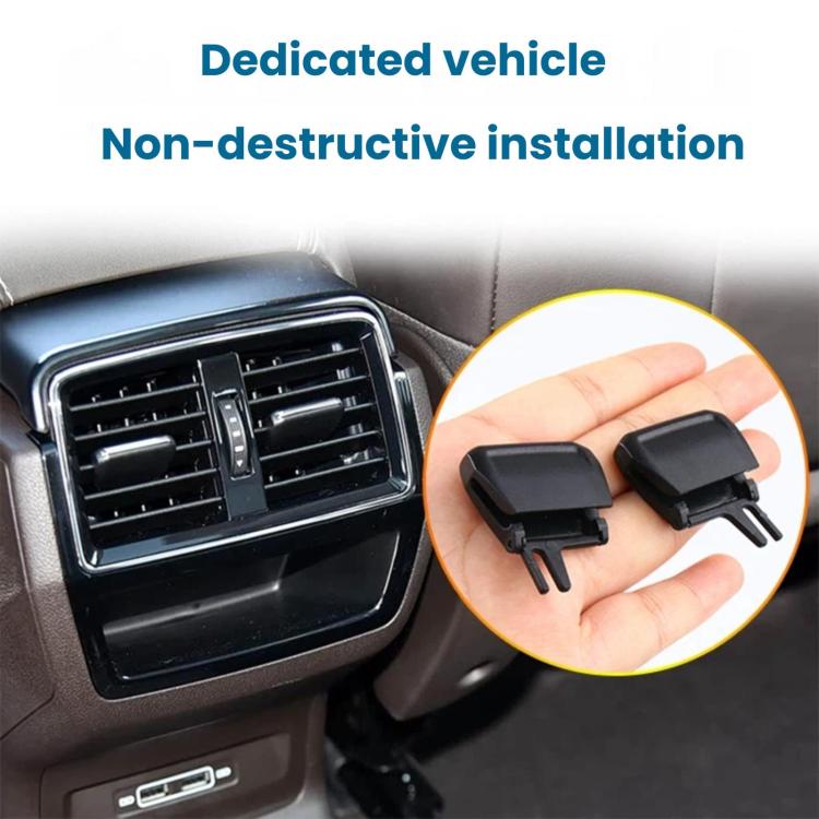 Black air vent grille paddle clips in hand, non-destructive style with two prongs