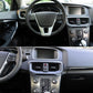 Car dashboard center area with air vent grille and surrounding black trim