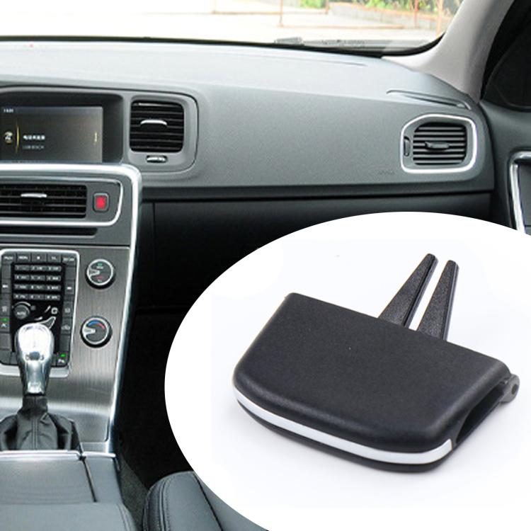 Black air vent paddle insert with two prongs shown beside car dashboard