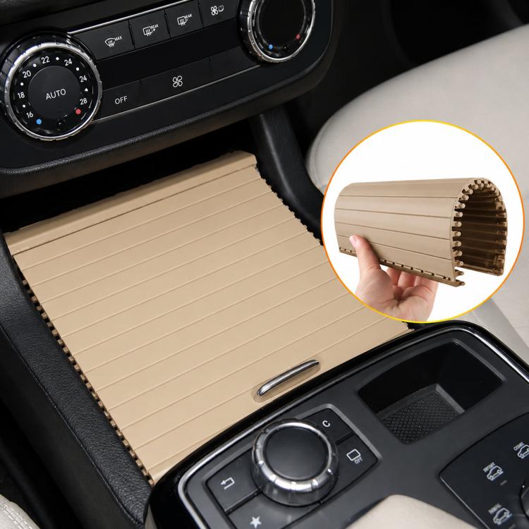 Black ribbed cup holder roller cover shown above beige interior trim