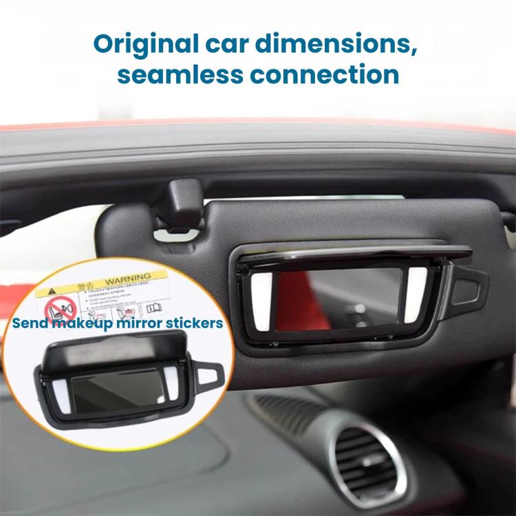 Sun visor vanity mirror installed on car dashboard with rectangular viewing window.