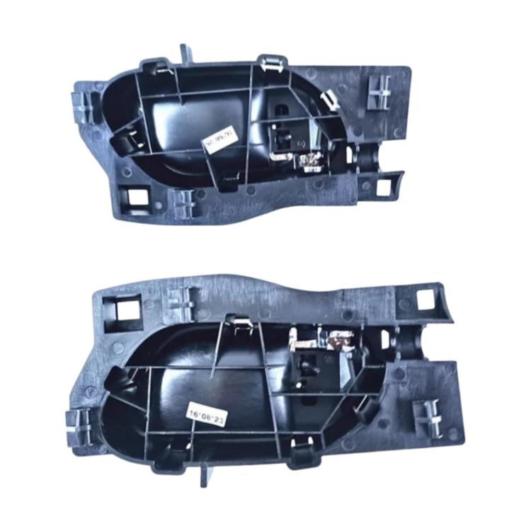 Car interior door handle housing with black mounting frame and internal parts