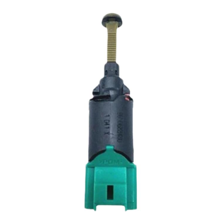 Brake light switch with green connector and black housing, metal threaded actuator pin