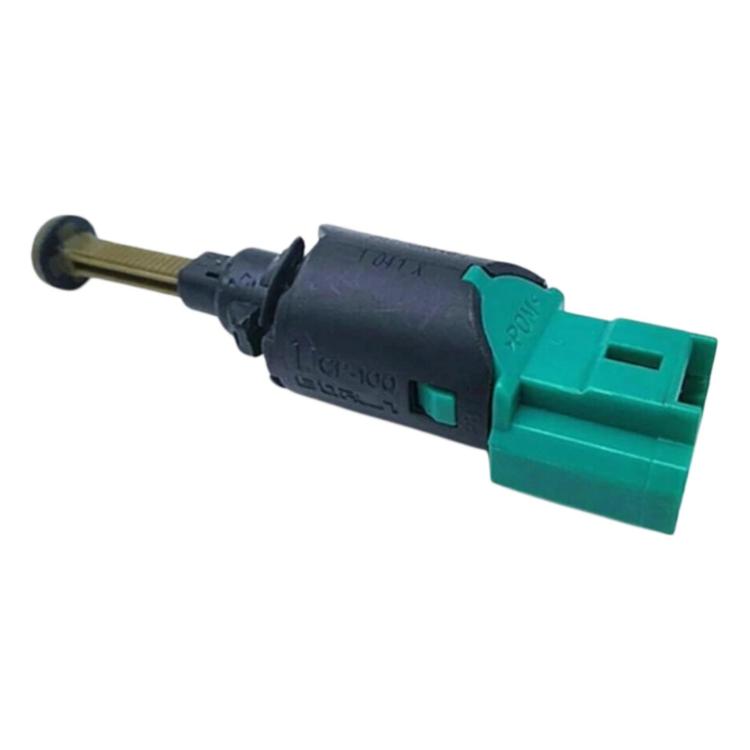 Brake light switch with green tab connector, black housing, and angled metal actuator pin