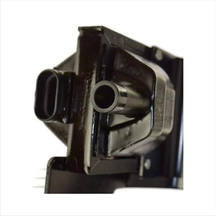 Close-up ignition coil end with rubber connector boot and metal housing