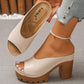 Beige peep-toe platform mule sandal with chunky block heel, shown in hand