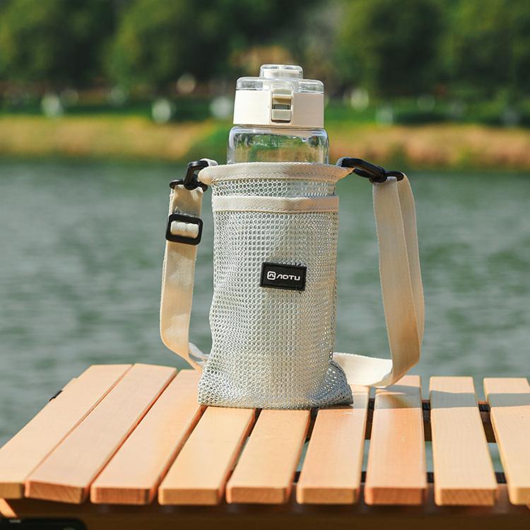 Beige mesh water bottle holder bag with adjustable shoulder strap and front pocket