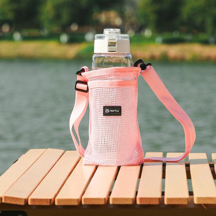 Pink mesh water bottle holder bag with adjustable shoulder strap and front pocket