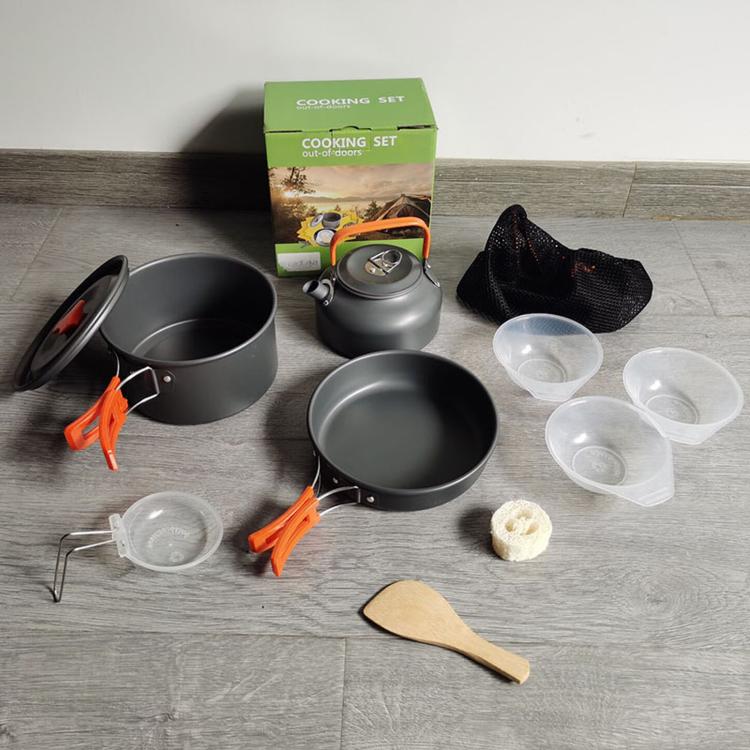 9-piece camping cookware set with gray pots, bowls, kettle, and utensils in box