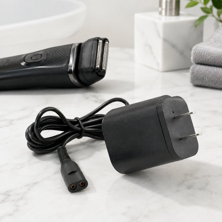 Black US plug power adapter with coiled cable and 2-pin shaver connector