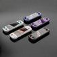 Handheld game consoles in white, black, and purple with gamepad controllers