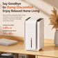 White compact dehumidifier standing on a tabletop, front vent and light indicator