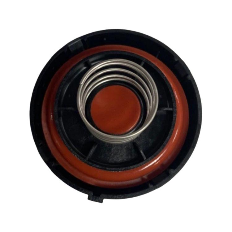 Car valve cover cap with orange center insert and metal spring coil