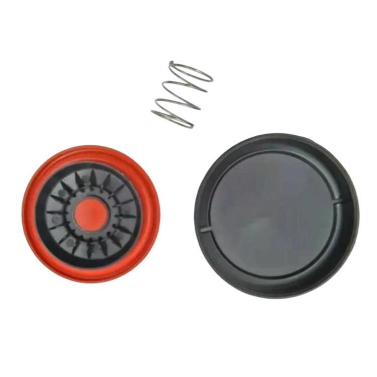 Valve cover kit components: black cap, orange gasket, and small metal spring