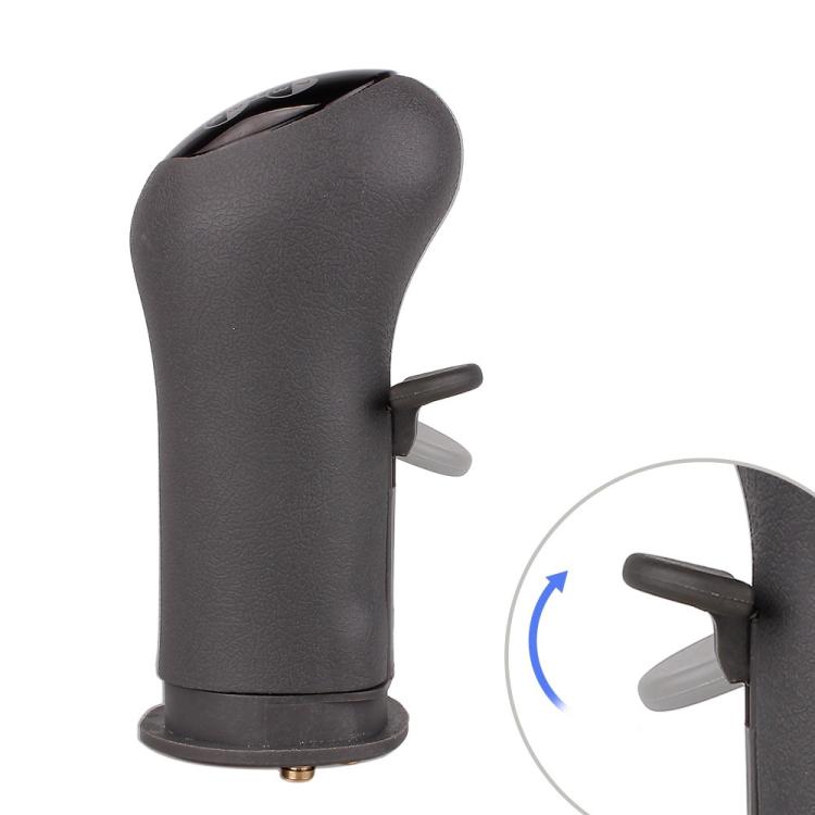 Black textured gear shift knob with side thumb lever and visible base opening