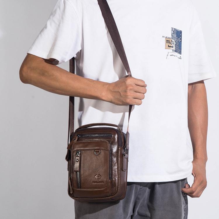 Brown leather crossbody bag worn by a man with adjustable shoulder strap