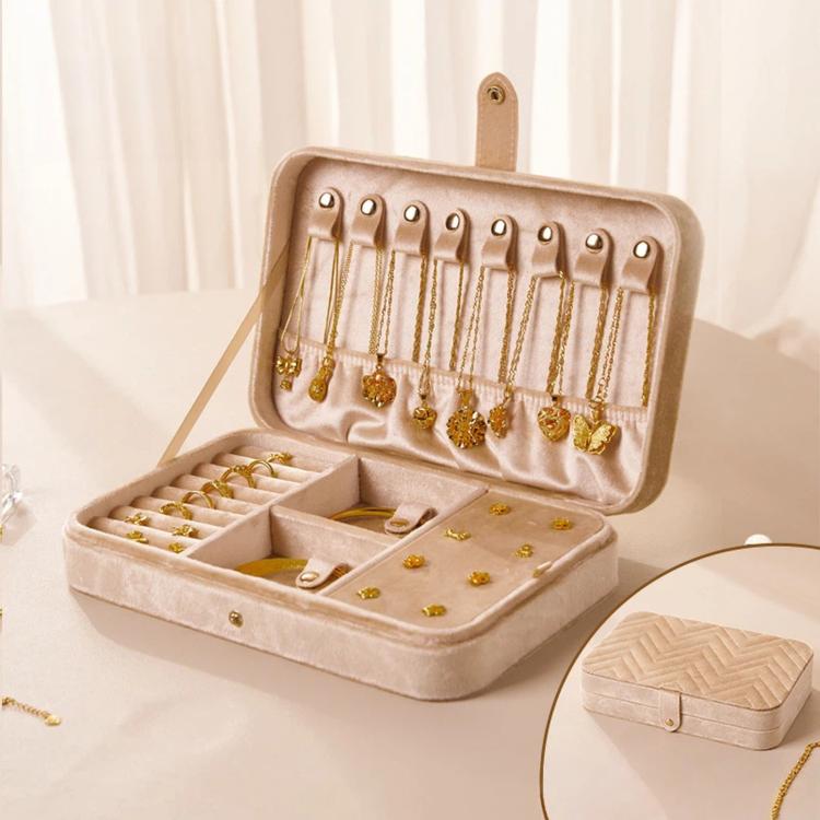 Light velvet jewelry box with hinged lid open, earring hooks, ring slots, and drawer sections