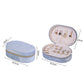 Light blue velvet oval jewelry case with zipper, open earring stud board and compartments