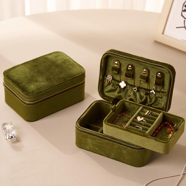 Emerald green velvet travel jewelry box with double zipper, open with earring and ring sections