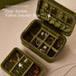 Emerald green velvet travel jewelry box with double zipper, open with ring, earring and bracelet slots
