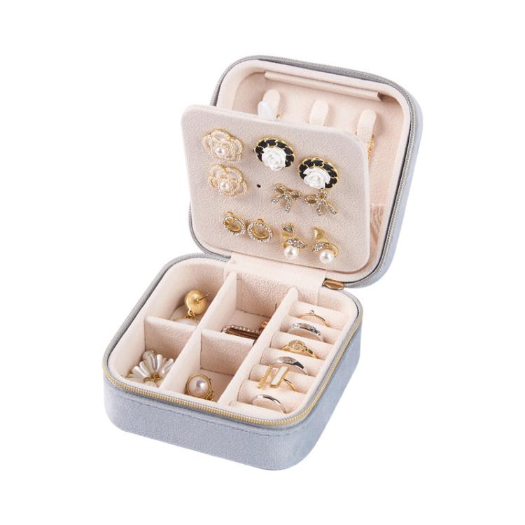 Mini velvet travel jewelry box in gray, open with stud panel and necklace hook slots