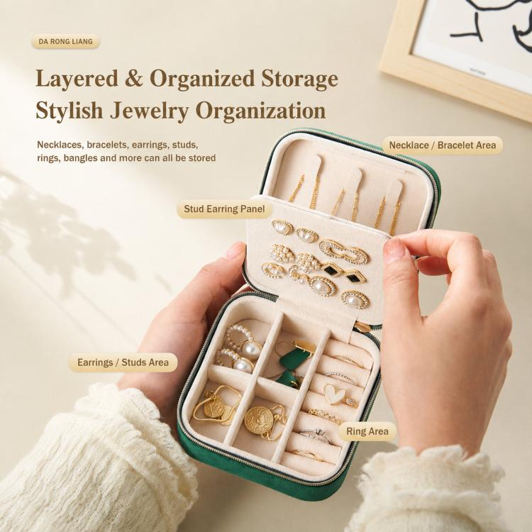 Mini velvet travel jewelry box held open with stud panel, ring slots, and hooks
