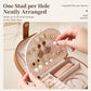 Open brown shell jewelry box interior with earring panel and ring sections