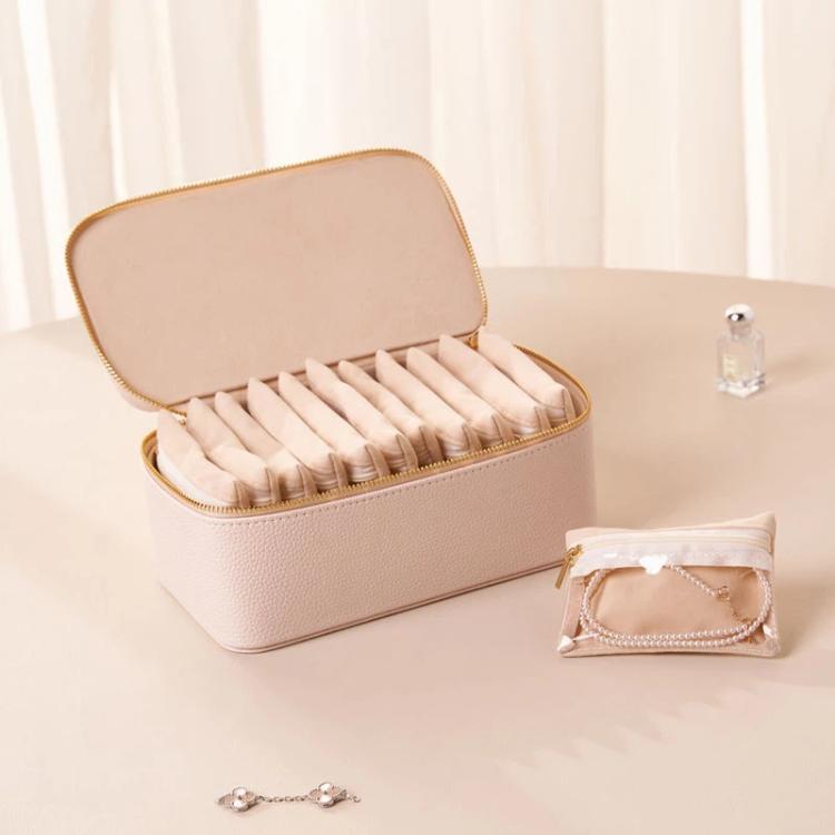 White PU jewelry organizer box with open lid and 12 clear zip pouches with jewelry slots