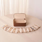Brown PU jewelry storage case with snap-closure lid and clear zip pouches laid out