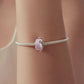 Silver bracelet with small pink glass bead charm showing an angel figure
