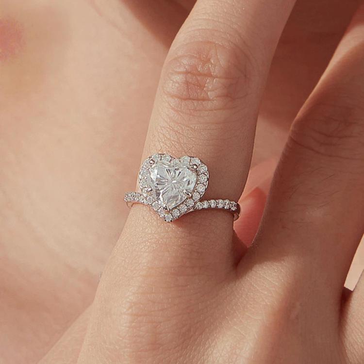 Heart-shaped moissanite ring in sterling silver with pavé halo and band
