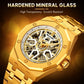 Men's skeleton automatic watch close-up, gold case with gold bracelet, exposed dial