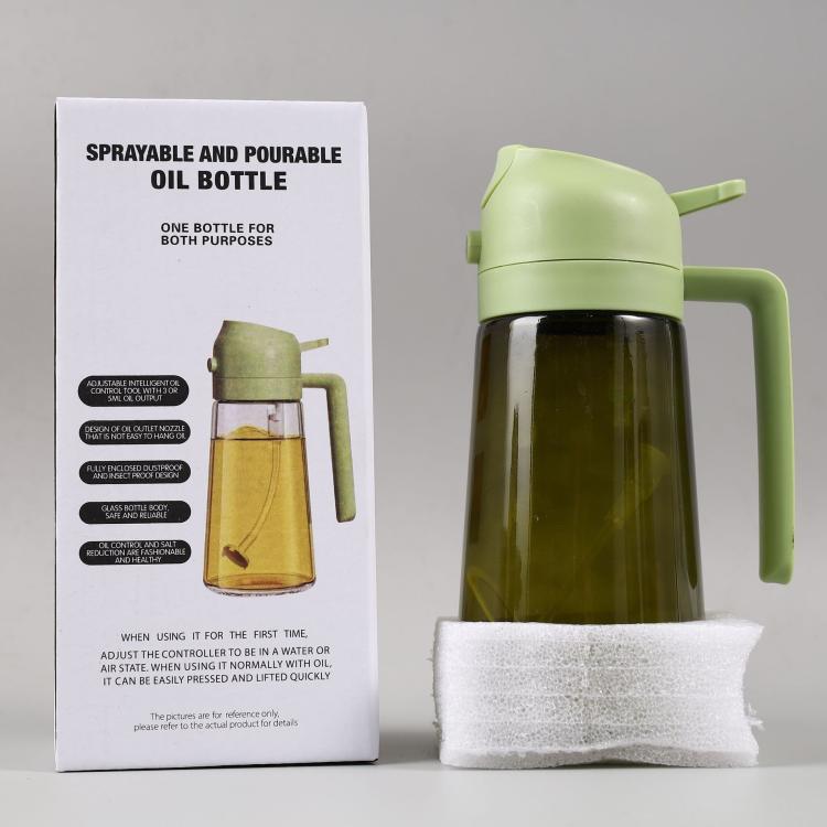 Light green sprayer oil bottle with handle and clear glass body filled with dark oil