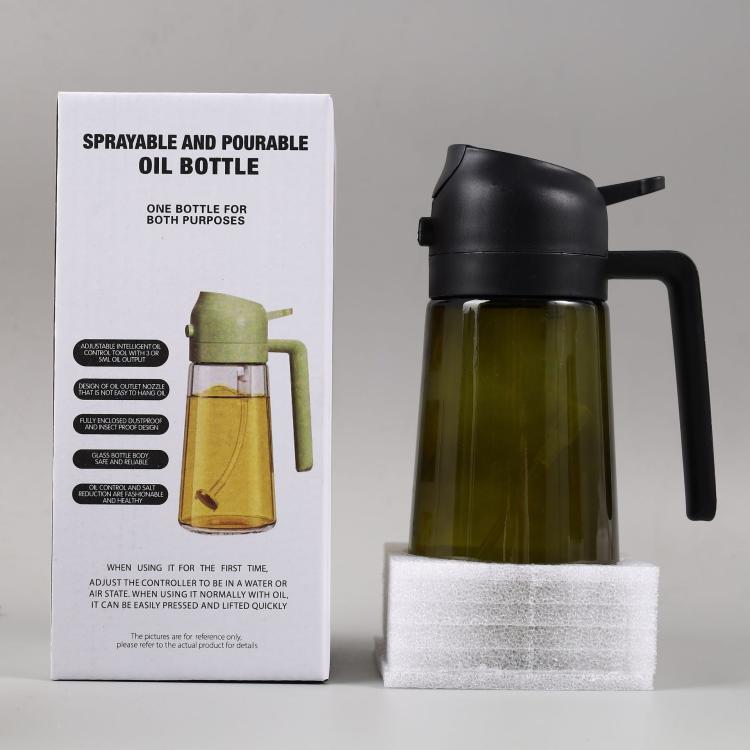 Black sprayer oil bottle with handle and clear glass body filled with dark oil