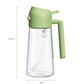 Clear glass oil mister with light green pump, spray head, and side handle