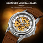 Silver-tone skeleton automatic watch with brown leather strap, side crown visible