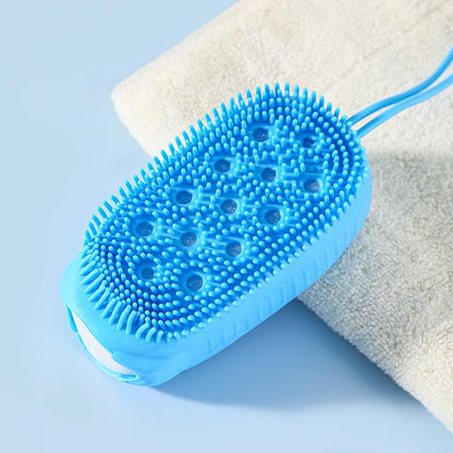 Blue oval silicone body scrubber with small bristle tips on a bath sponge backing.
