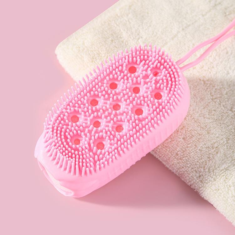 Pink oval silicone body scrubber with small bristle tips on a bath sponge backing.