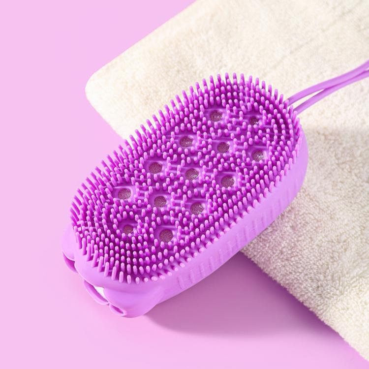 Purple oval silicone body scrubber with small bristle tips on a bath sponge backing.