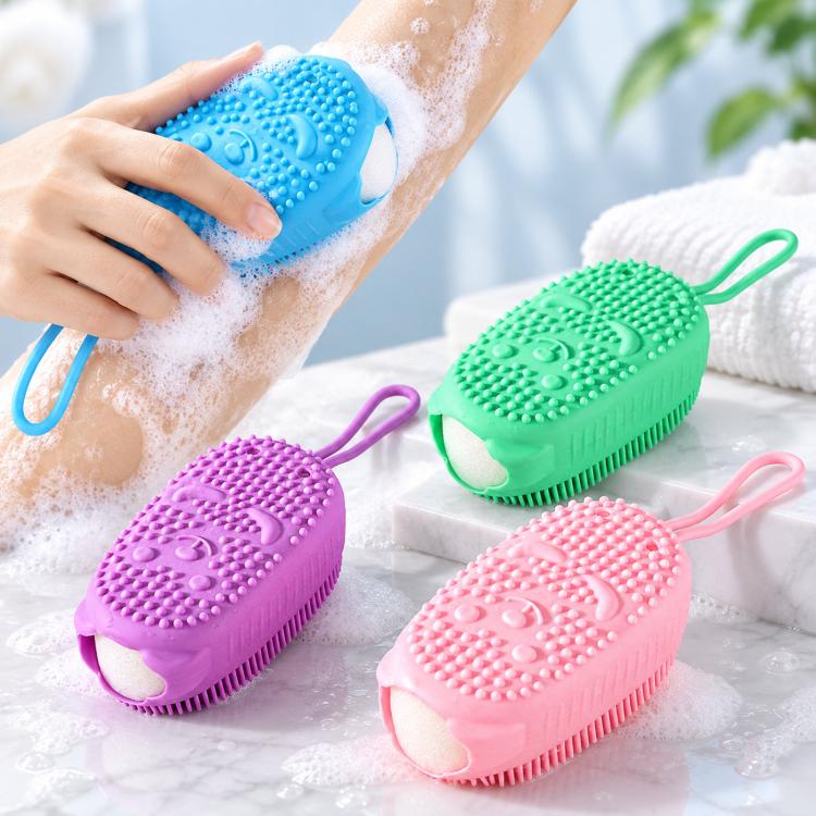 Assorted color silicone bath scrubbers with lanyards shown on a shower surface with foam.