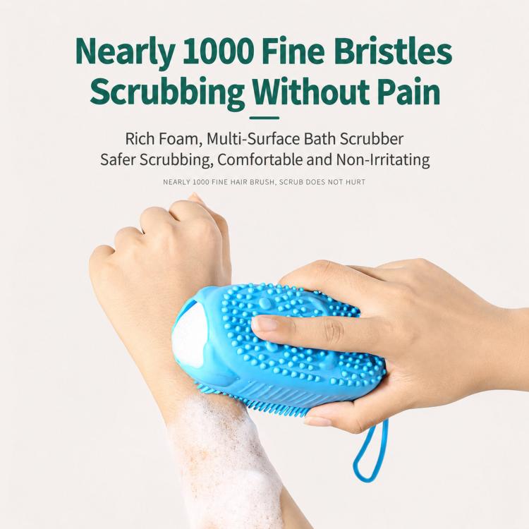 Blue silicone body scrubber with bristle tips held against skin covered in rich foam.