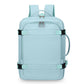 Light blue expandable travel backpack with zip front pocket, top handle, and side carry loop.