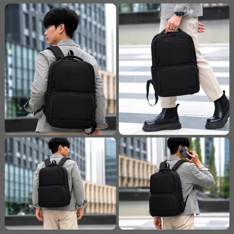 Black laptop backpack worn by a man, featuring side handle and front zip pocket