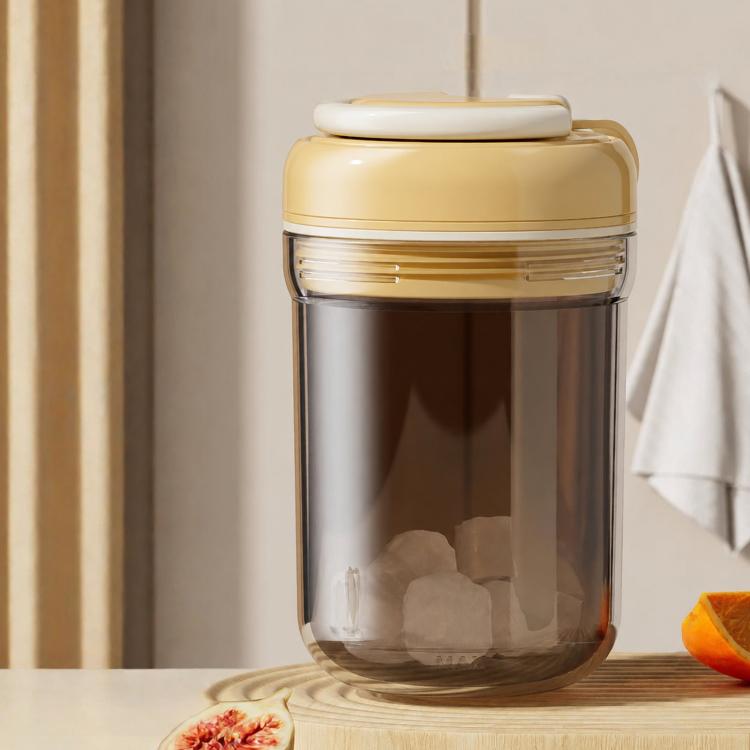 Beige portable ice press cup with lid; clear container shows ice blocks