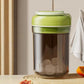 Green portable ice press cup with lid; clear container shows ice blocks