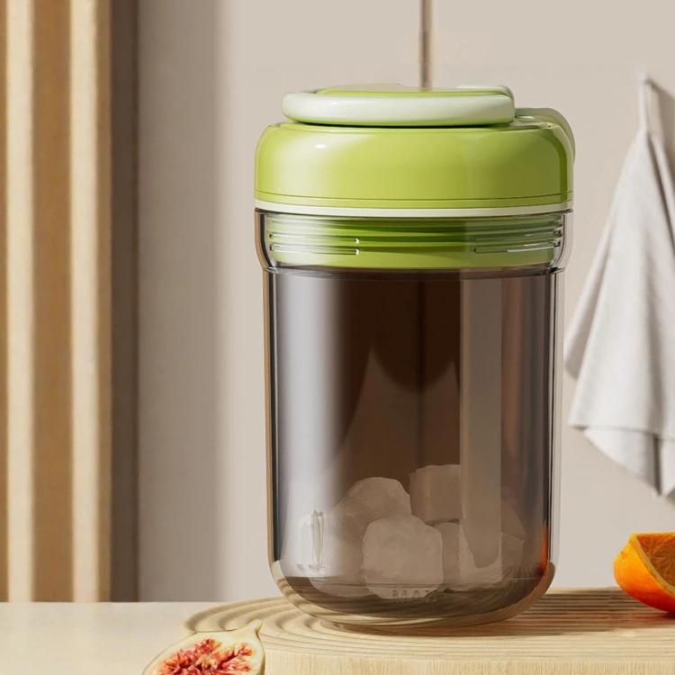 Green portable ice press cup with lid; clear container shows ice blocks
