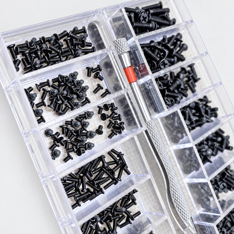 Close-up of clear compartments filled with black Phillips micro screws