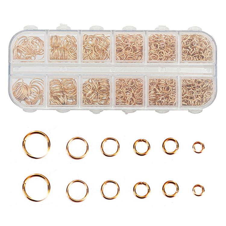 Gold and white open jump rings set with mixed sizes in clear storage box and loose rings