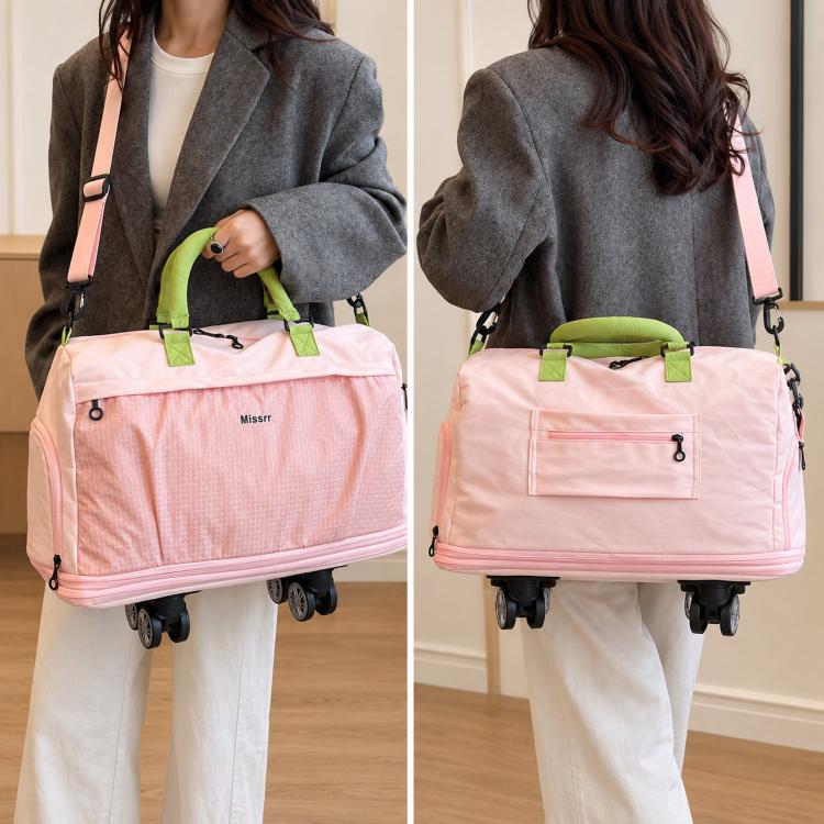 Pink nylon rolling duffel bag carried by a woman with crossbody strap and wheels