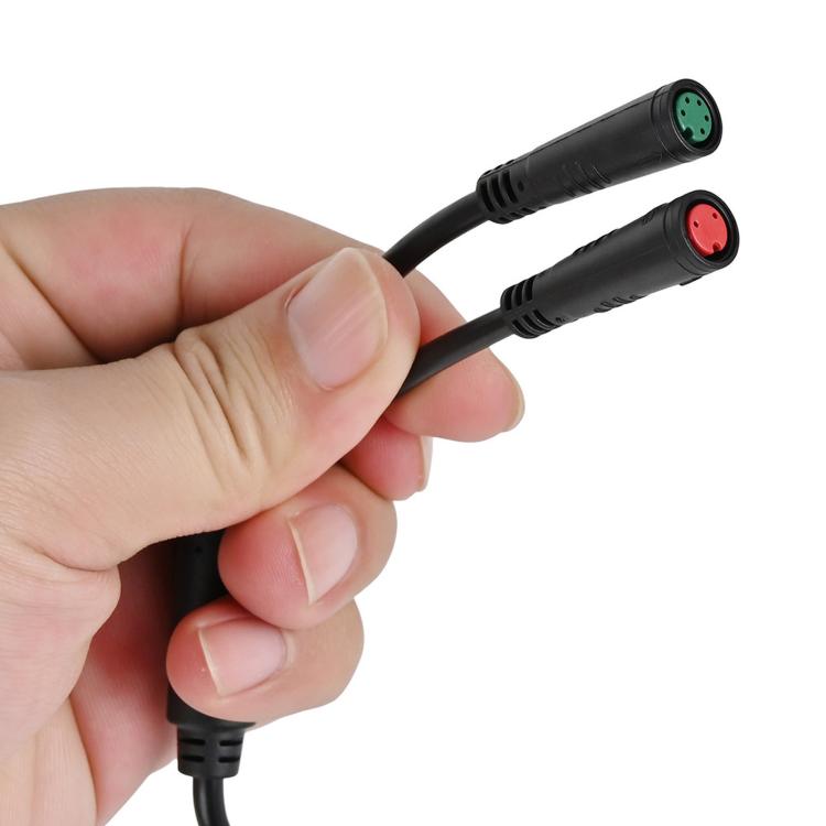 Wiring harness connector plugs close-up: black cable with green and red 2-pin ends